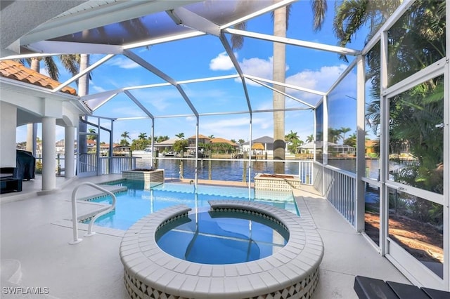 view of swimming pool with a water view, glass enclosure, a pool with connected hot tub, and a patio area