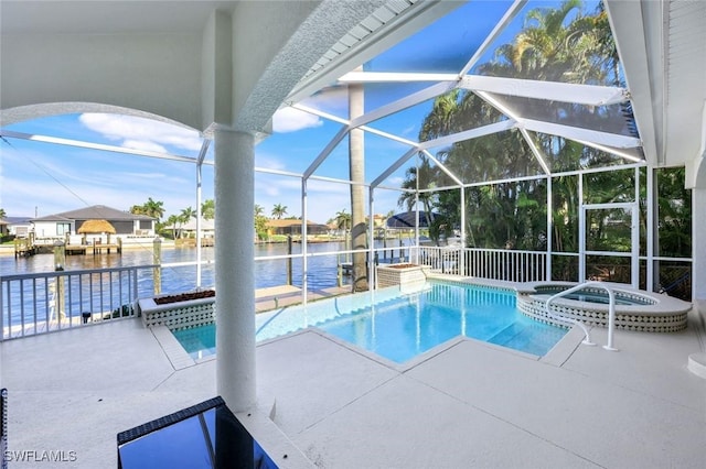 view of swimming pool with a water view, a pool with connected hot tub, a patio area, and a lanai
