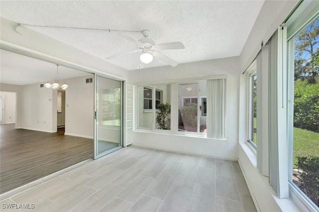 7400 College Pkwy Unit 5A, Fort Myers, FL 33907 - unfurnished sunroom featuring a chandelier, baseboards, and a textured ceiling
