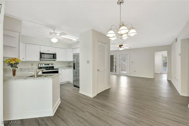 7400 College Pkwy Unit 5A, Fort Myers, FL 33907 - kitchen featuring stainless steel appliances, ceiling fan, a chandelier, light wood finished floors, and open shelves