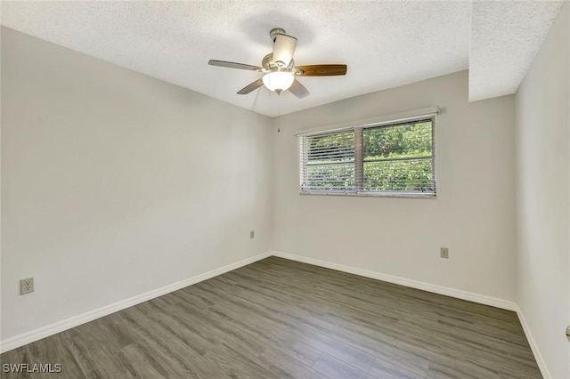 7400 College Pkwy Unit 5A, Fort Myers, FL 33907 - unfurnished room featuring wood finished floors, a textured ceiling, baseboards, and ceiling fan