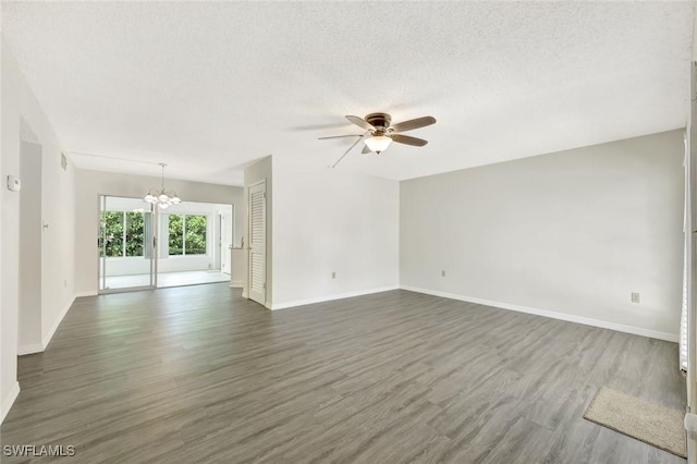 7400 College Pkwy Unit 5A, Fort Myers, FL 33907 - unfurnished living room with ceiling fan, a chandelier, dark wood-style floors, baseboards, and a textured ceiling