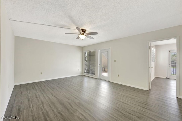 7400 College Pkwy Unit 5A, Fort Myers, FL 33907 - unfurnished room with a ceiling fan, dark wood-style floors, a textured ceiling, and baseboards