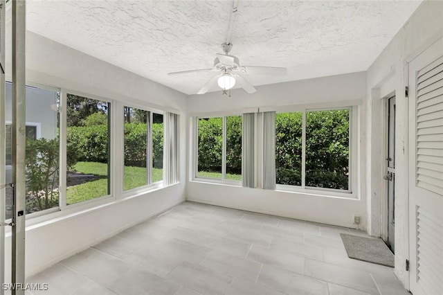 7400 College Pkwy Unit 5A, Fort Myers, FL 33907 - unfurnished sunroom featuring a textured ceiling and tile patterned flooring