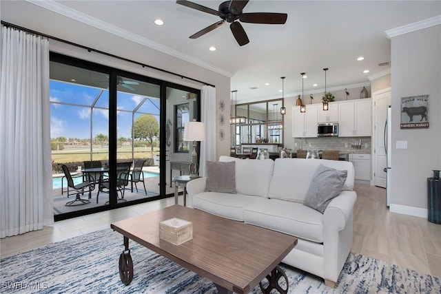 1421 Lucena Ln S, Naples, FL 34113 - living room featuring a ceiling fan, healthy amount of natural light, recessed lighting, ornamental molding, and baseboards