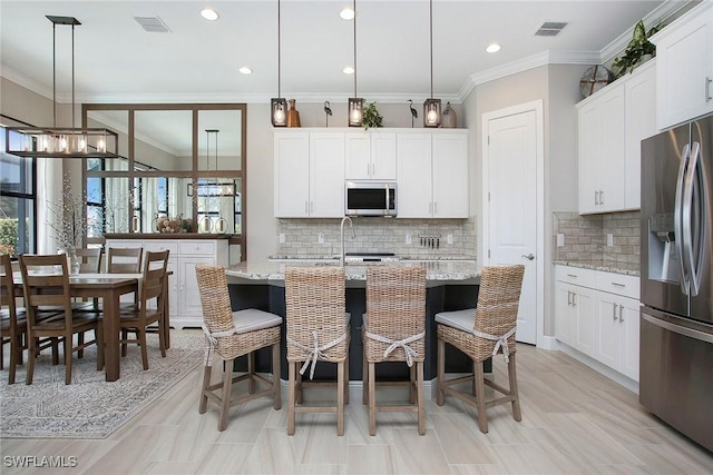 1421 Lucena Ln S, Naples, FL 34113 - kitchen with appliances with stainless steel finishes, healthy amount of natural light, white cabinetry, backsplash, and crown molding