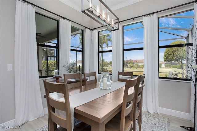 1421 Lucena Ln S, Naples, FL 34113 - dining space featuring baseboards, crown molding, and light wood finished floors