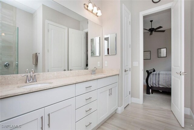 1421 Lucena Ln S, Naples, FL 34113 - full bathroom featuring ceiling fan, baseboards, double vanity, and tiled shower