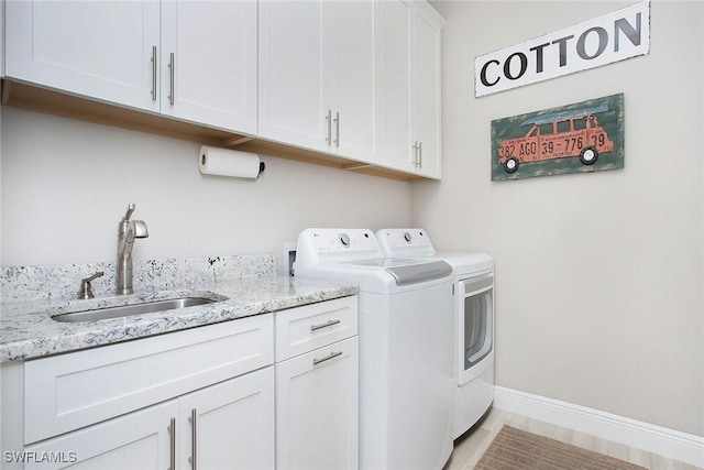 1421 Lucena Ln S, Naples, FL 34113 - laundry room featuring washer and clothes dryer, cabinet space, and baseboards