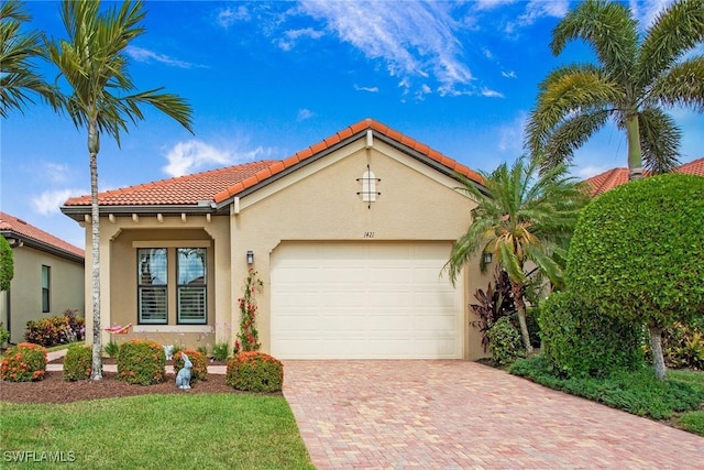 1421 Lucena Ln S, Naples, FL 34113 - mediterranean / spanish-style home featuring a tiled roof, decorative driveway, an attached garage, and stucco siding