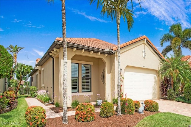 1421 Lucena Ln S, Naples, FL 34113 - mediterranean / spanish-style house featuring stucco siding, a garage, a tiled roof, and driveway