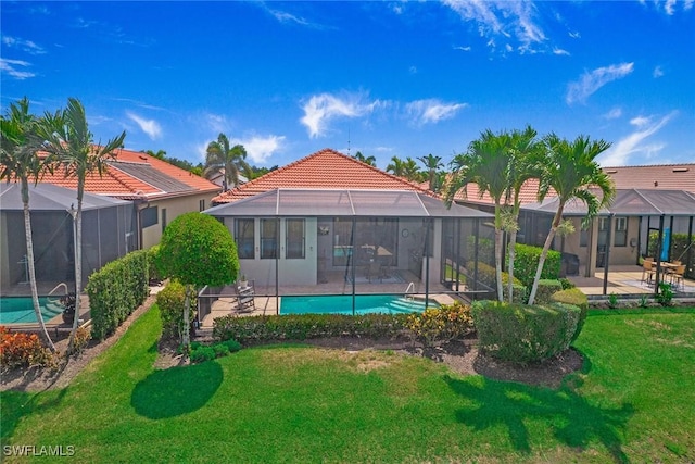 1421 Lucena Ln S, Naples, FL 34113 - back of house with an outdoor pool, a patio area, a tile roof, and a yard