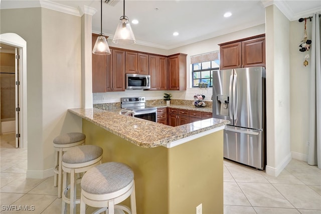kitchen with stainless steel appliances, ornamental molding, a peninsula, arched walkways, and light tile patterned floors