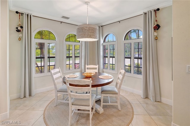 dining area featuring light tile patterned floors and baseboards