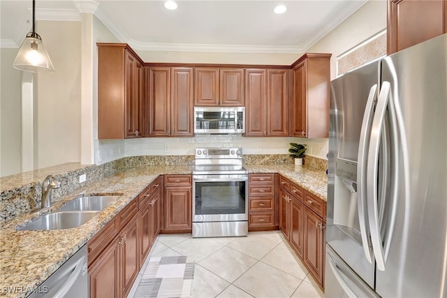 kitchen with appliances with stainless steel finishes, a sink, light stone counters, pendant lighting, and brown cabinetry