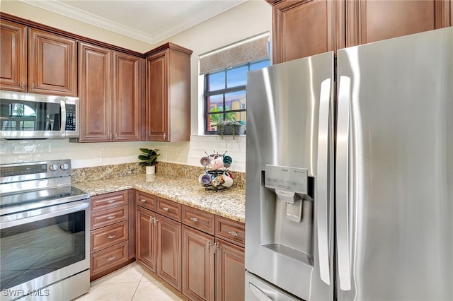 kitchen featuring stainless steel appliances, light stone counters, ornamental molding, and brown cabinets
