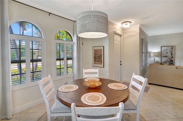 dining space featuring plenty of natural light, light tile patterned floors, ornamental molding, and baseboards