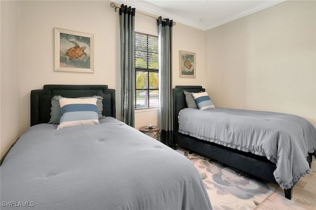 bedroom featuring crown molding and wood finished floors