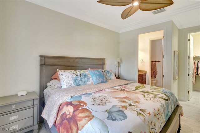 bedroom with ornamental molding, ensuite bathroom, and a ceiling fan