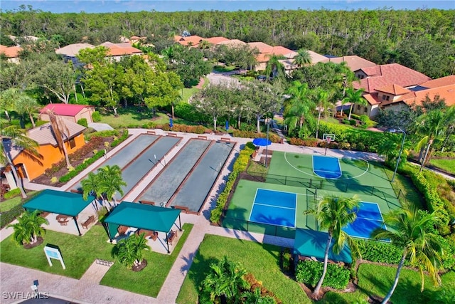aerial perspective of suburban area featuring a heavily wooded area