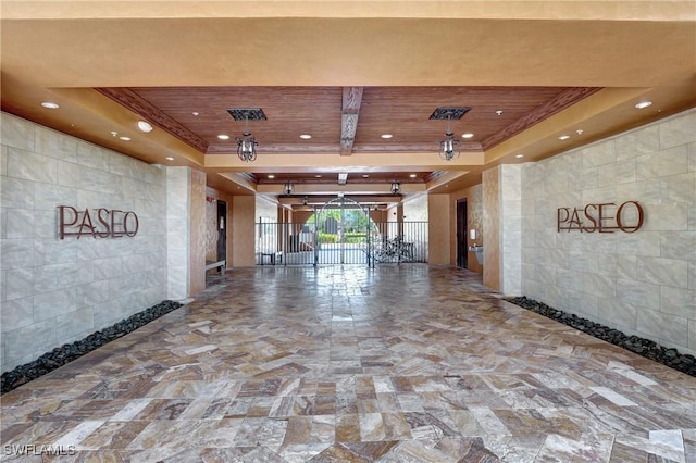 building lobby featuring tile walls, wooden ceiling, and crown molding