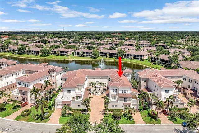 aerial view of residential area featuring a large body of water
