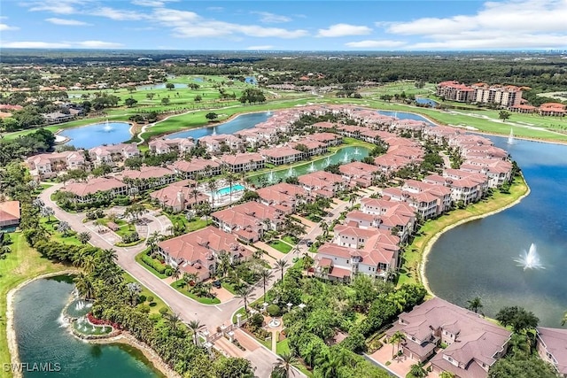 view of property location with a large body of water and nearby suburban area