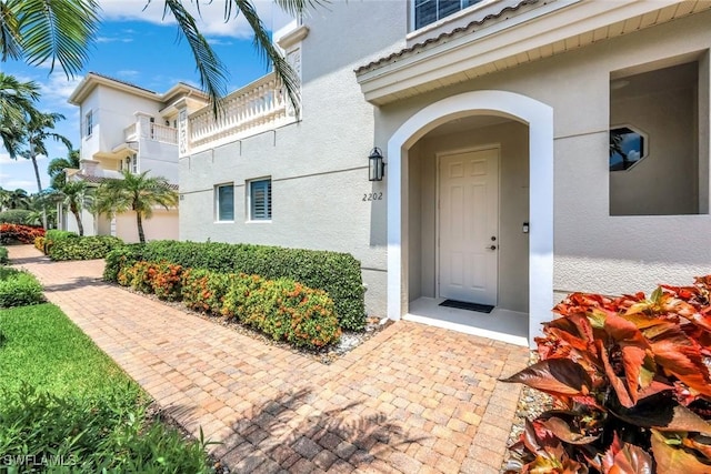 doorway to property with stucco siding