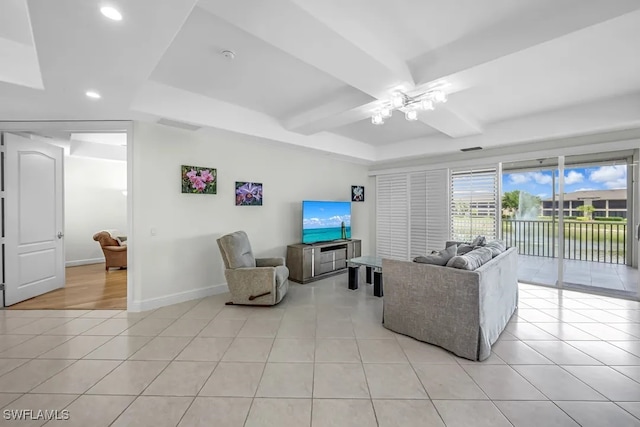 living area with ceiling fan, recessed lighting, light tile patterned floors, a raised ceiling, and baseboards