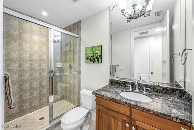 bathroom with a shower stall, a chandelier, toilet, vanity, and recessed lighting