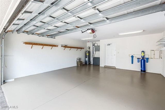 garage featuring water heater, a garage door opener, and heating unit