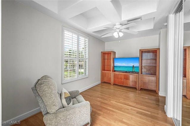 sitting room featuring light wood-style floors, baseboards, and a ceiling fan