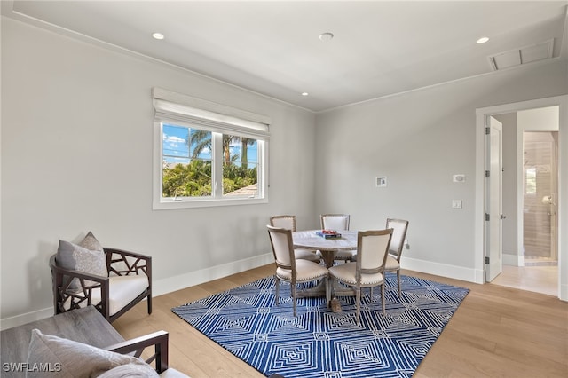 dining space with light wood finished floors, baseboards, and recessed lighting