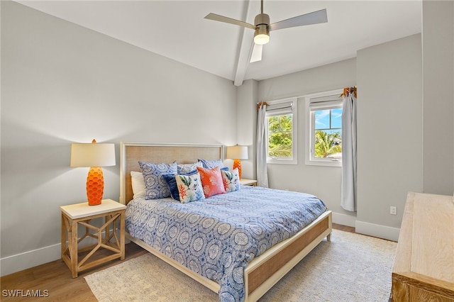 bedroom with baseboards, wood finished floors, and ceiling fan