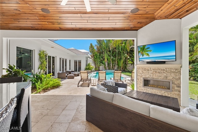view of patio / terrace featuring an outdoor living space with a fireplace and outdoor dining area