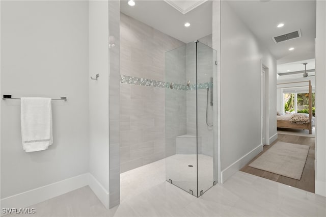 ensuite bathroom with baseboards, walk in shower, and recessed lighting