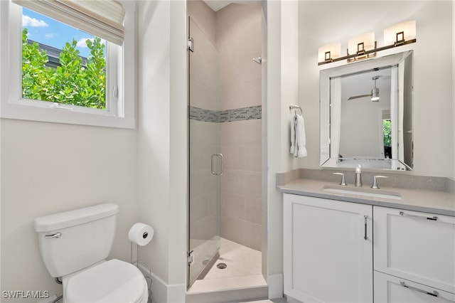full bath with a stall shower, toilet, and vanity