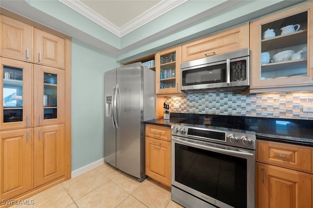 kitchen featuring stainless steel appliances, crown molding, tasteful backsplash, light tile patterned flooring, and glass insert cabinets