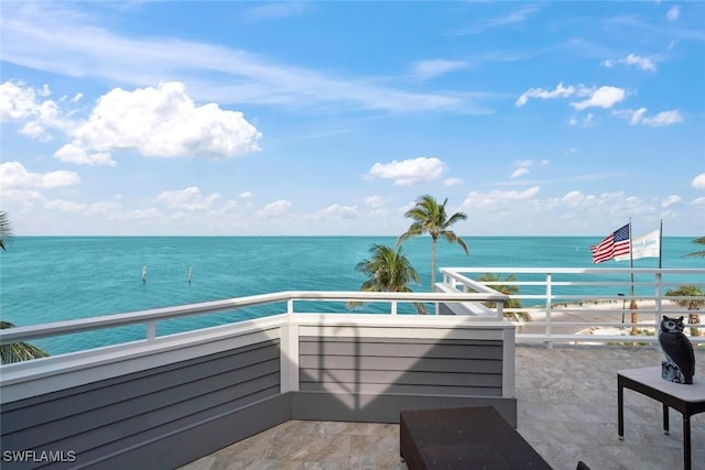 view of patio / terrace featuring a balcony and a water view