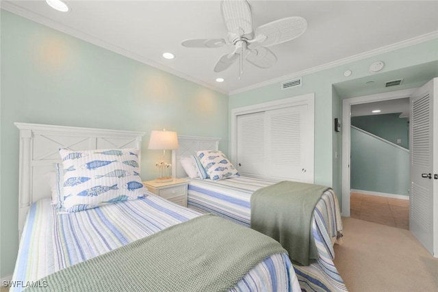 carpeted bedroom featuring a closet, crown molding, ceiling fan, recessed lighting, and tile patterned floors