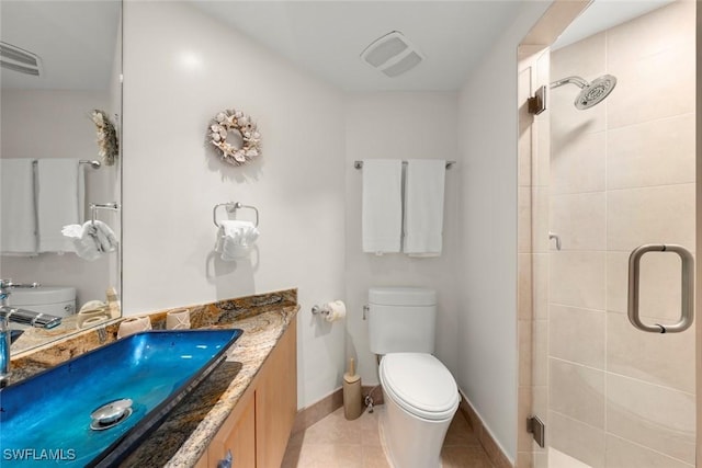 full bathroom with toilet, a stall shower, baseboards, and vanity