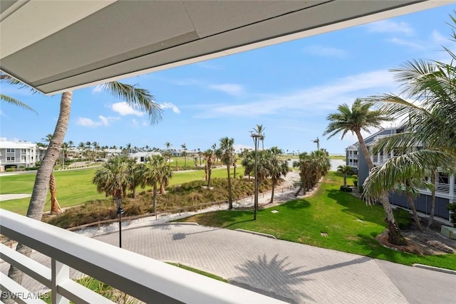 view of property's community with view of golf course, a residential view, and a yard