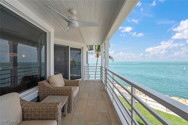 balcony with a ceiling fan and a water view