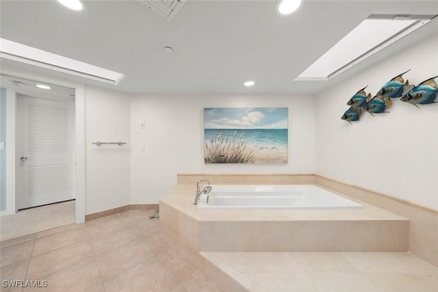 full bathroom featuring a skylight, tile patterned flooring, recessed lighting, and a bath
