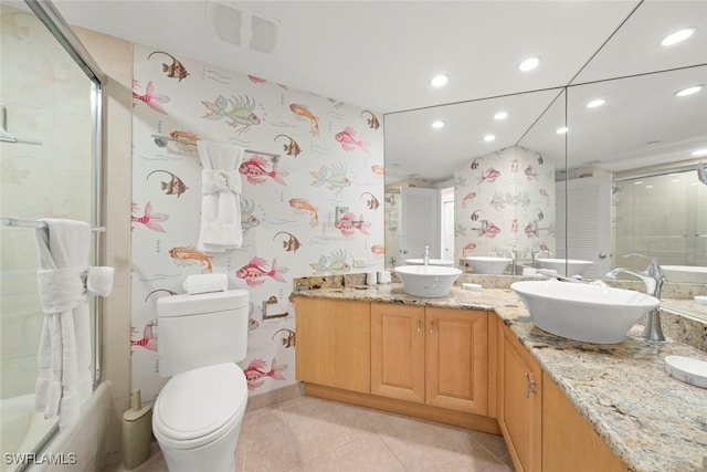bathroom featuring recessed lighting, tile patterned flooring, toilet, and double vanity