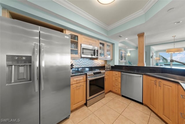 kitchen with stainless steel appliances, crown molding, ornate columns, dark countertops, and light tile patterned floors