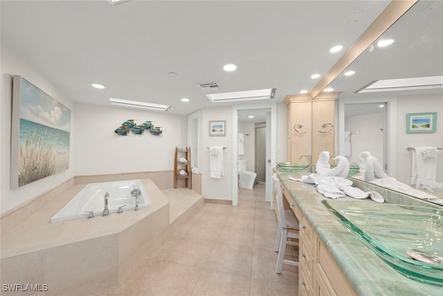 bathroom with toilet, a garden tub, double vanity, recessed lighting, and tile patterned floors