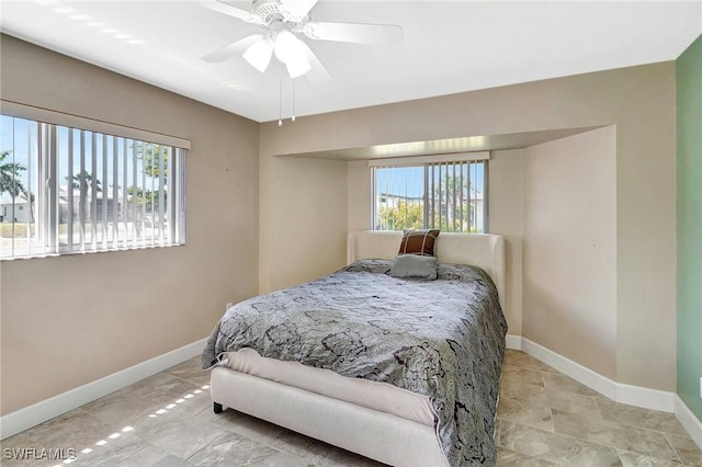 bedroom with baseboards and a ceiling fan