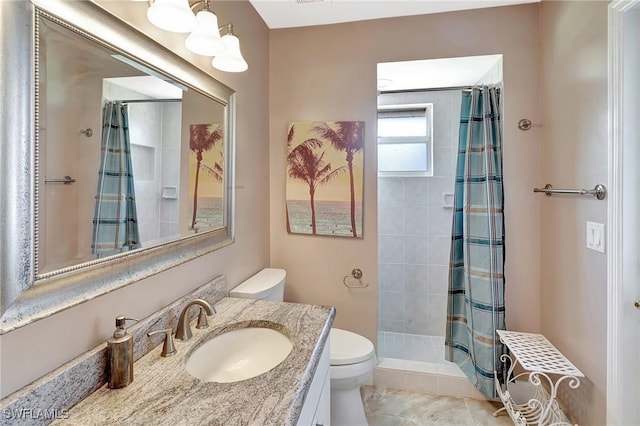 full bath with toilet, tiled shower, and vanity