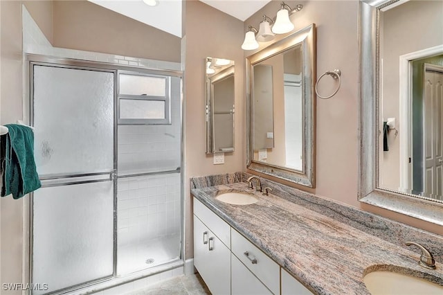 full bath with a stall shower and double vanity